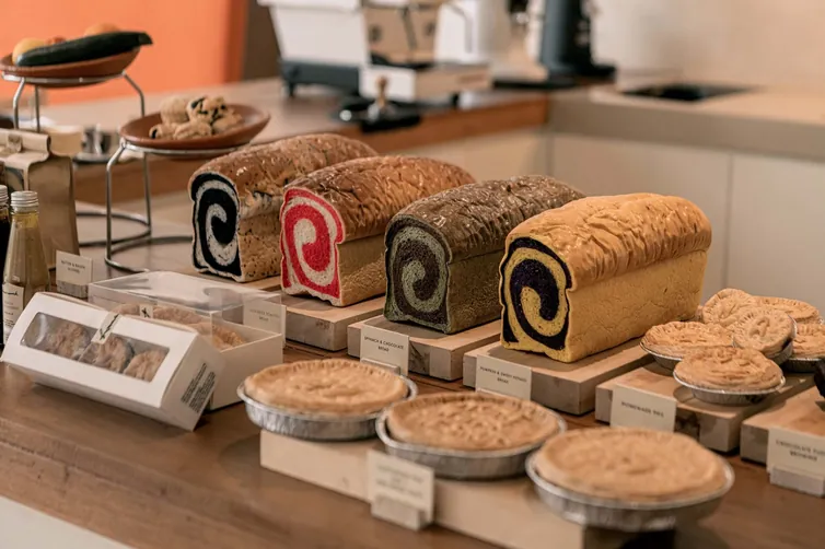 Loaves, pies and pastries laid out on the counter at Homework Cafe, Bangkok