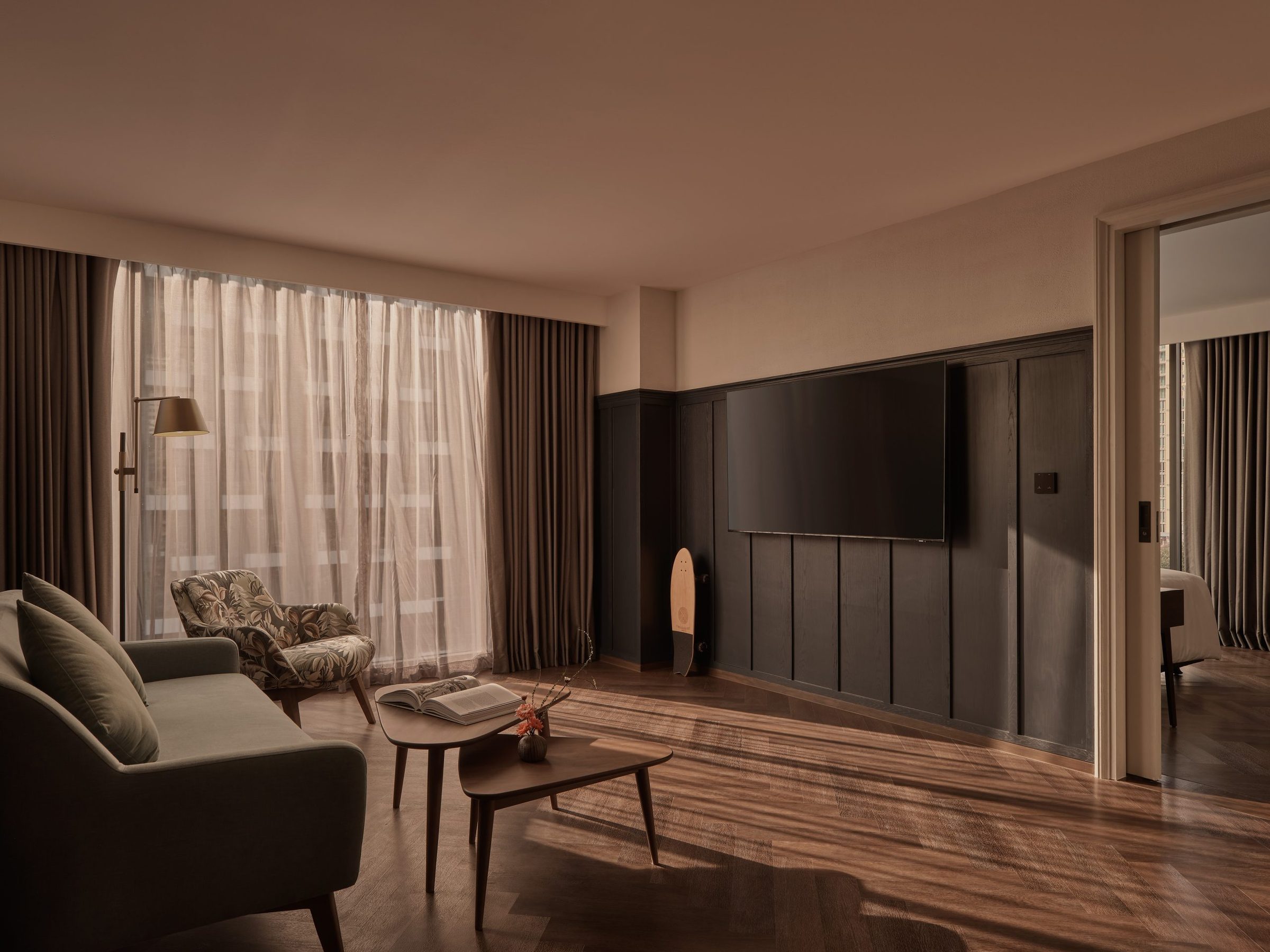 Living room with a sofa, a low table and a panelled media wall