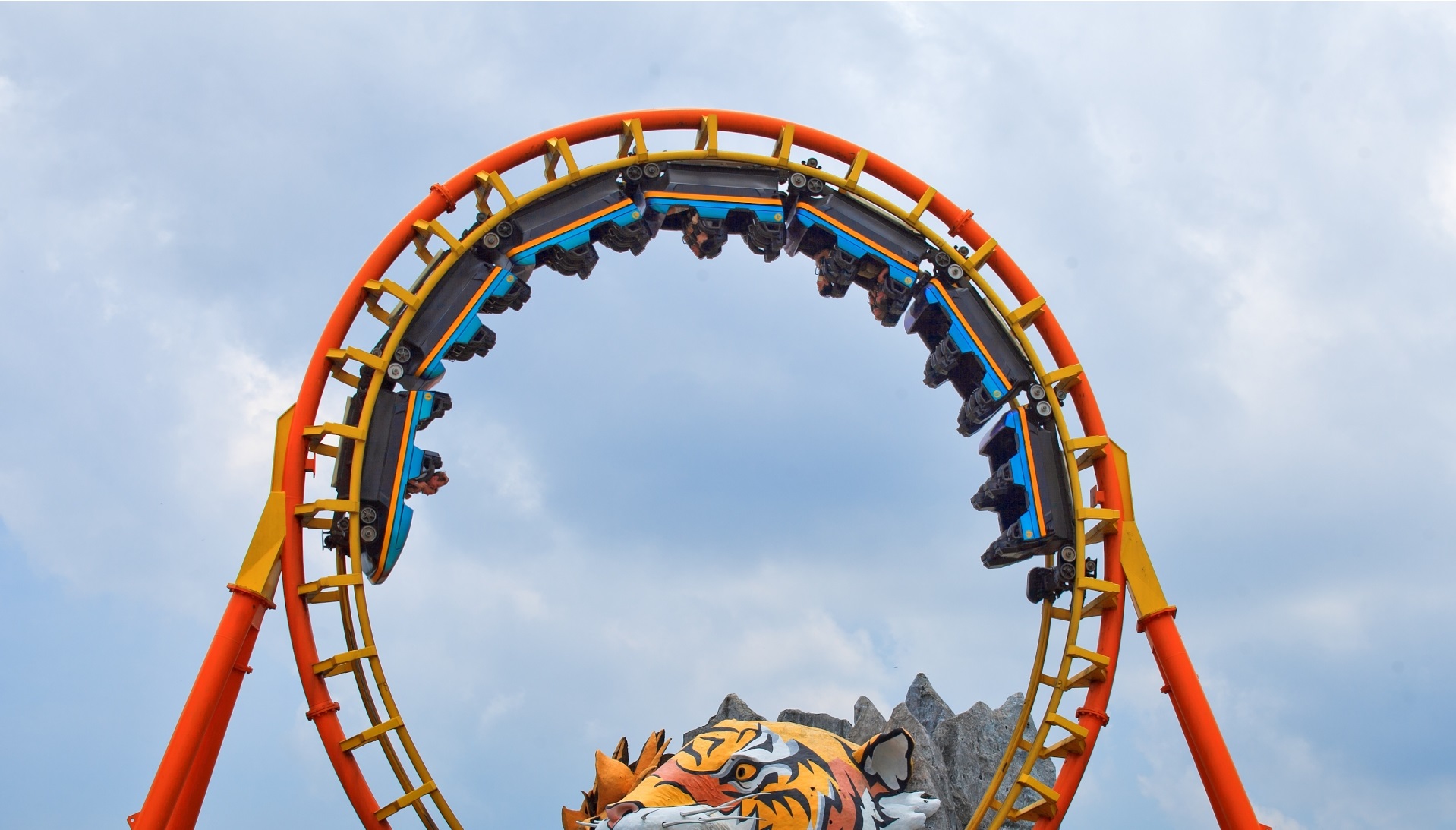A rollercoaster loop against a bright sky at a Bangkok amusement park
