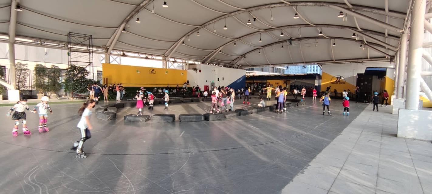Skaters on a covered rink under a tented roof in Bangkok