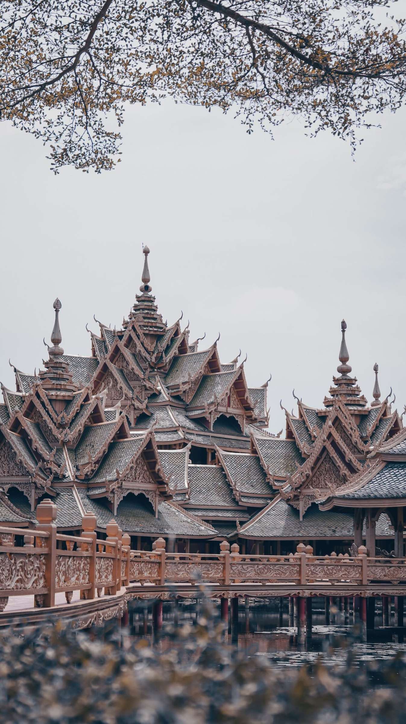 Tiered wooden temple roofs against a grey sky