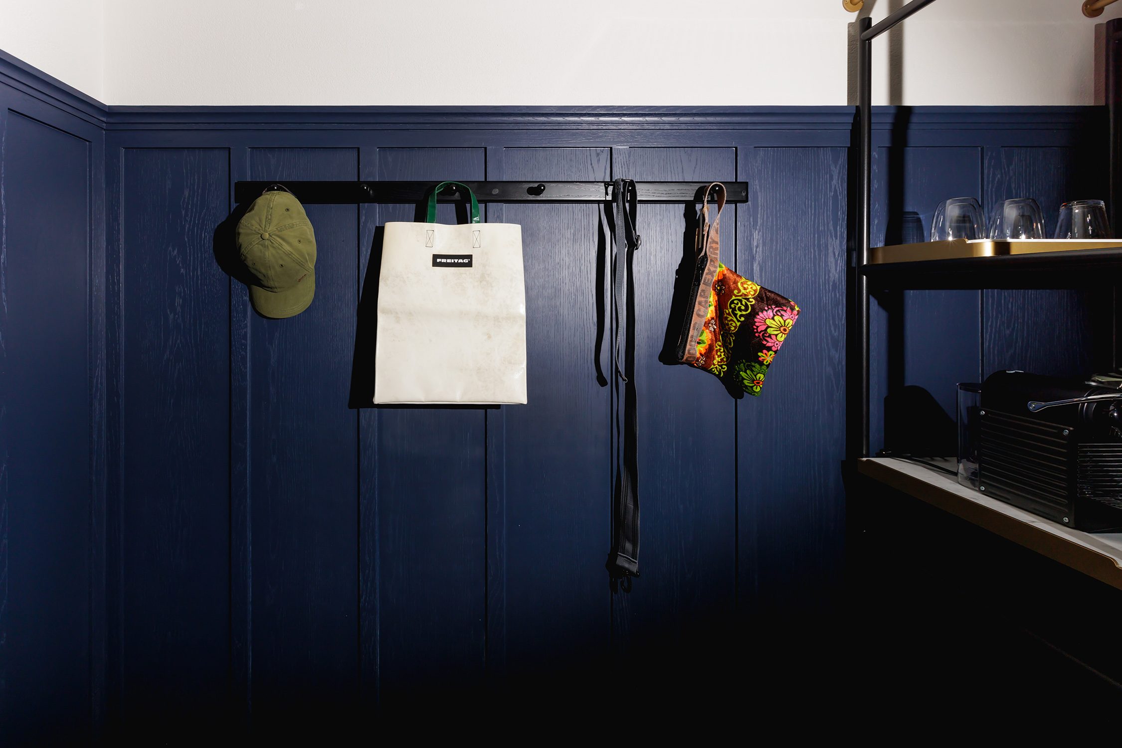 Navy panelled pantry with glassware and a coffee machine in the Two-Bedroom Suite