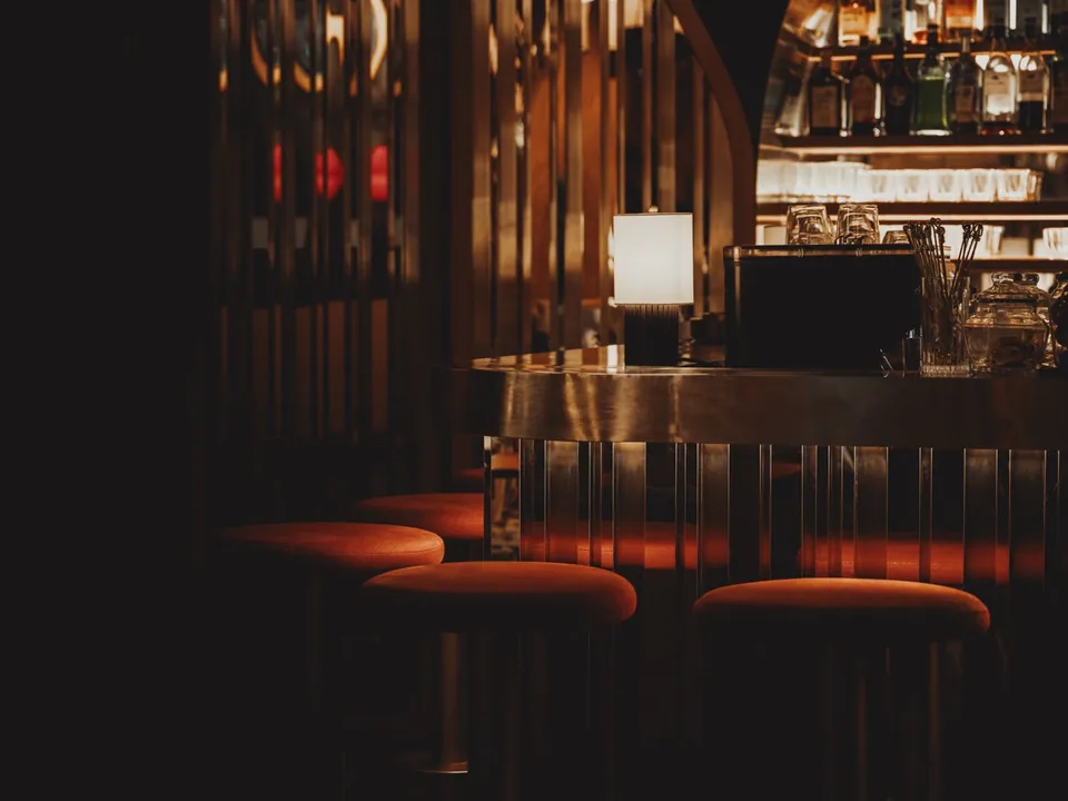 Sandwiches, croquettes and long drinks along the counter at SWD Bangkok