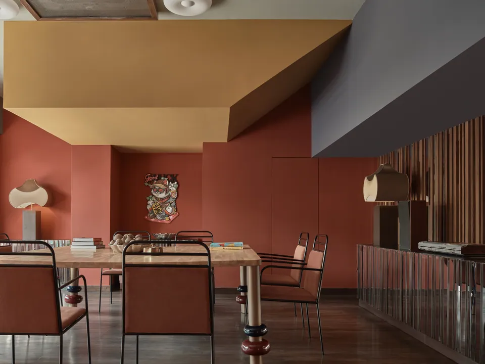 A FLEXI-ROOM meeting set-up at Public House Bangkok, with a long table and chairs against a terracotta wall