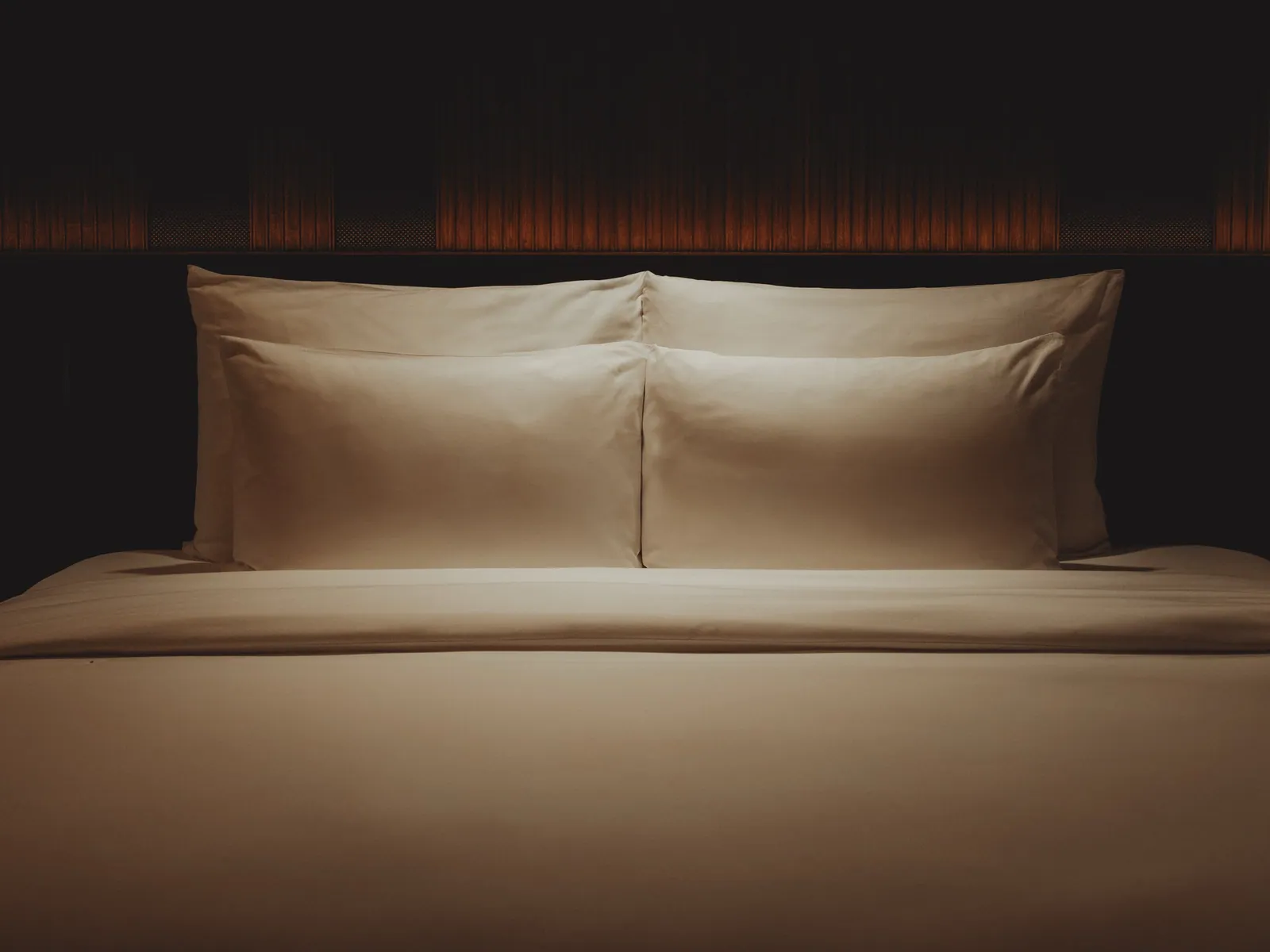 A made bed with linen pillows in a guest room at Public House Bangkok