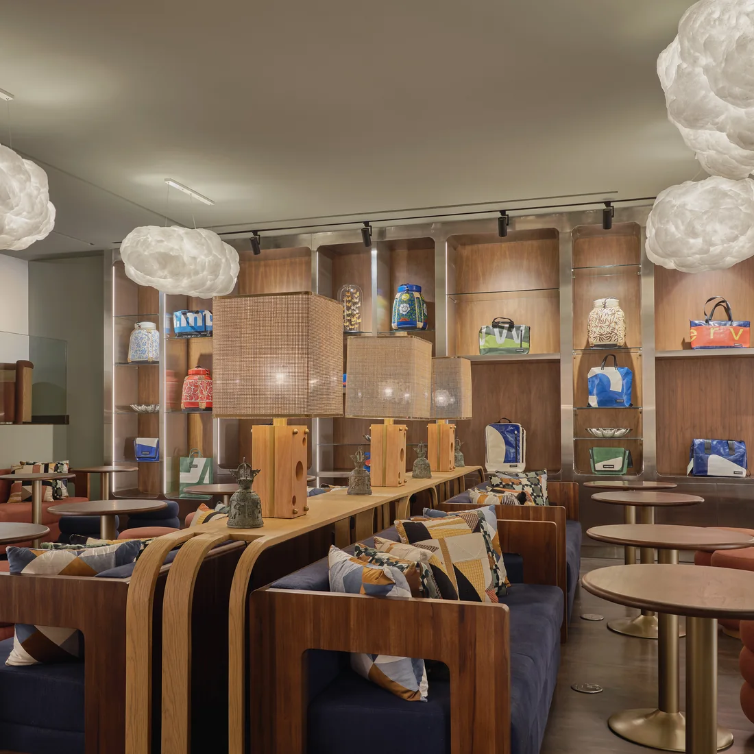 FORUM, the coworking zone at Public House Bangkok, with cloud pendant lights over curved timber banquettes