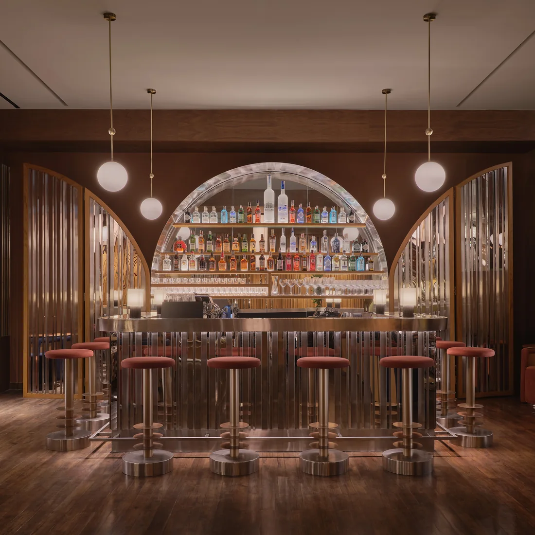 The arched, lit back bar at Public House Bangkok, a space bookable for private events