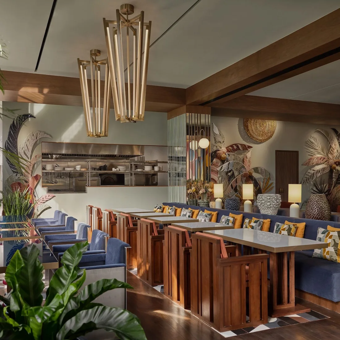 The lobby at Public House Bangkok, with brass lighting and an open kitchen