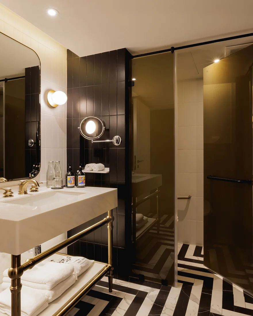 The Two-Bedroom Suite bathroom at Public House Bangkok, with a chevron floor
