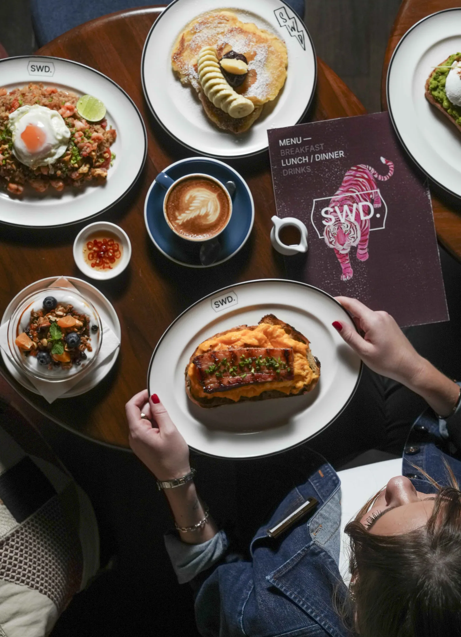 Breakfast for two at SWD Bangkok, with congee, toast and coffee on a round table