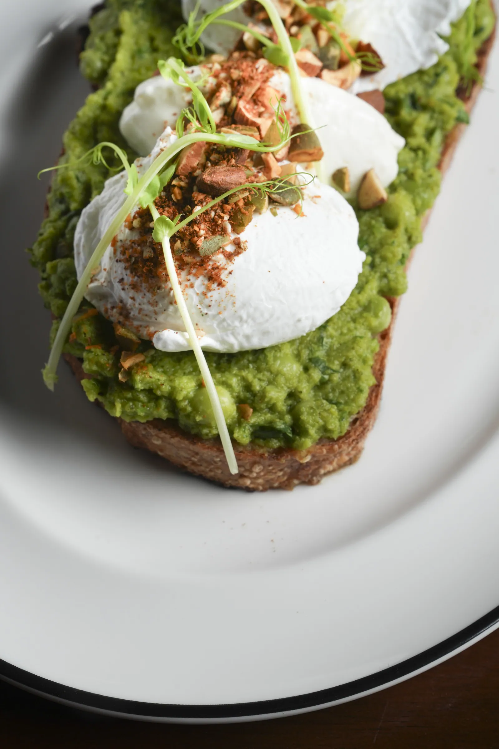 No-Avocado Toast at SWD Bangkok, poached eggs over pea smash on sourdough