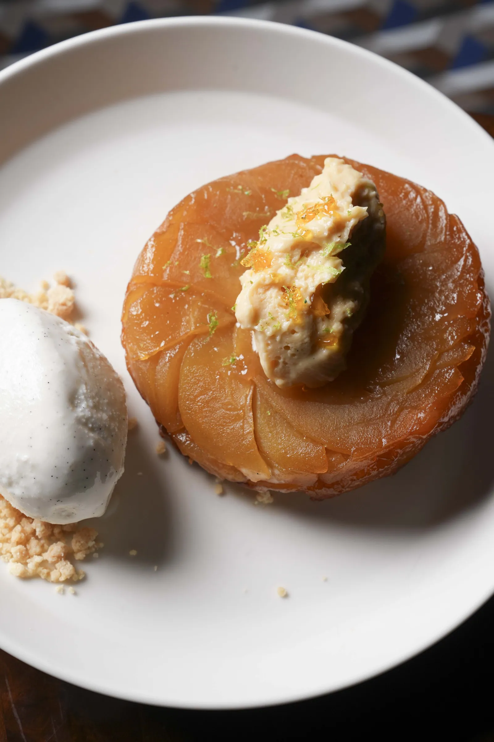 A caramelised apple tarte tatin at SWD with a scoop of ice cream on a bed of crumb